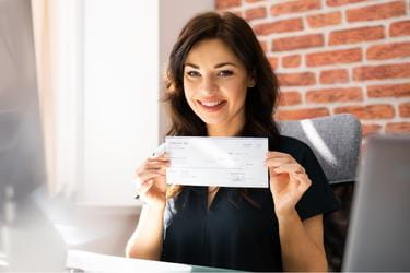 Woman holding her paycheck