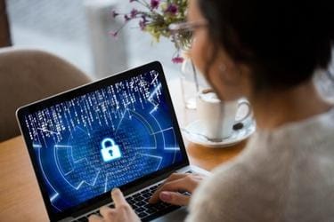Woman using a laptop with cybersecurity