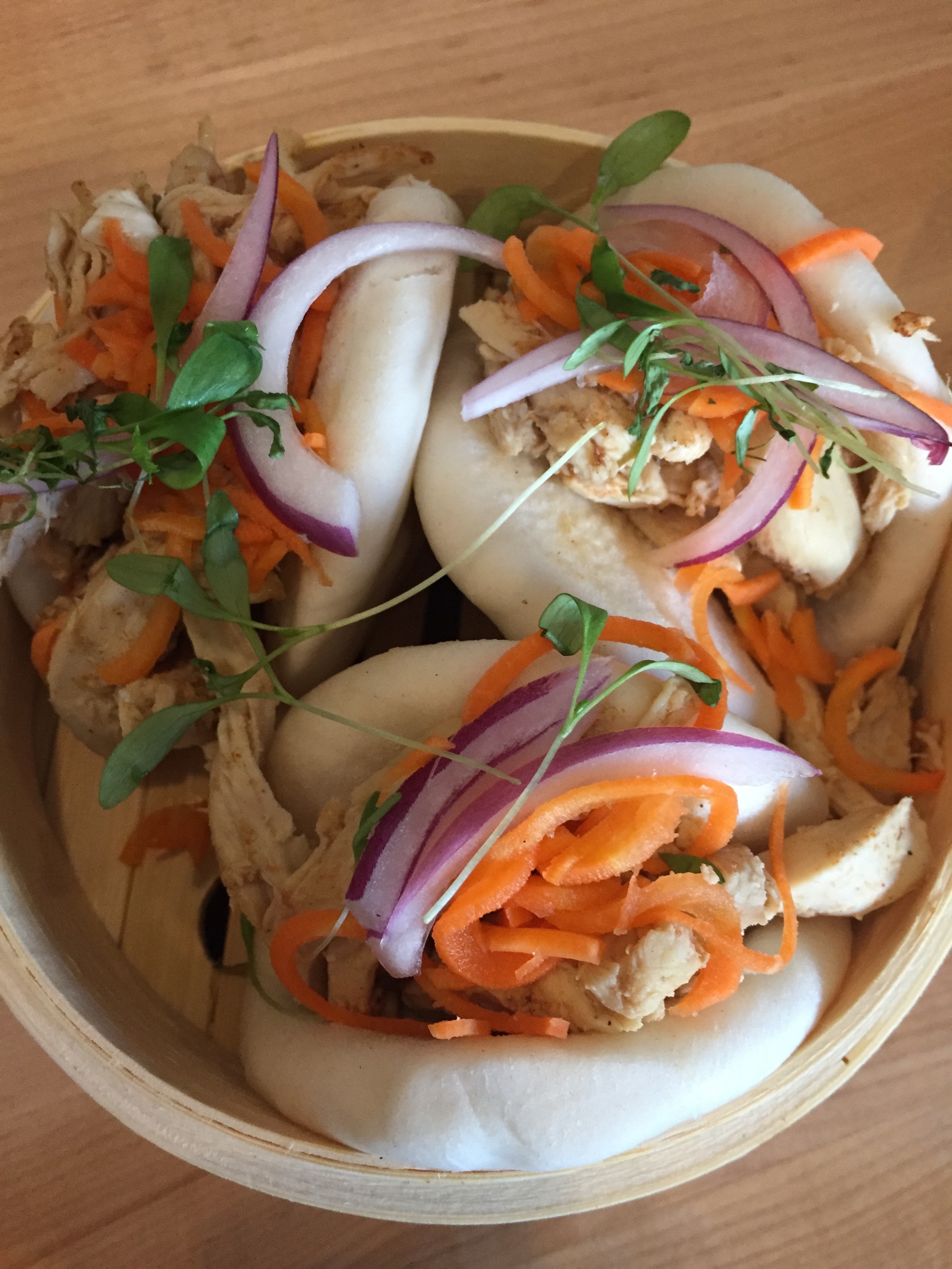 Chicken Bao Buns with braised chicken, pickled carrots, red onion, cilantro