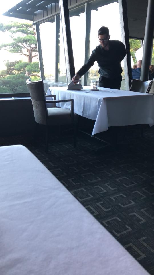 Ironing table cloth at Canlis