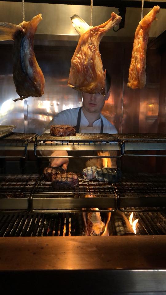 Grilling the meat on the woodfire grill at Canlis