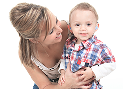 Mom shares a big moment with her toddler who has just gotten hearing aids.