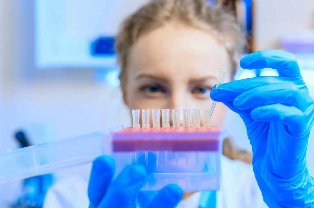 Woman in lab studying test tube samples. Click here to article about BerGenBio.