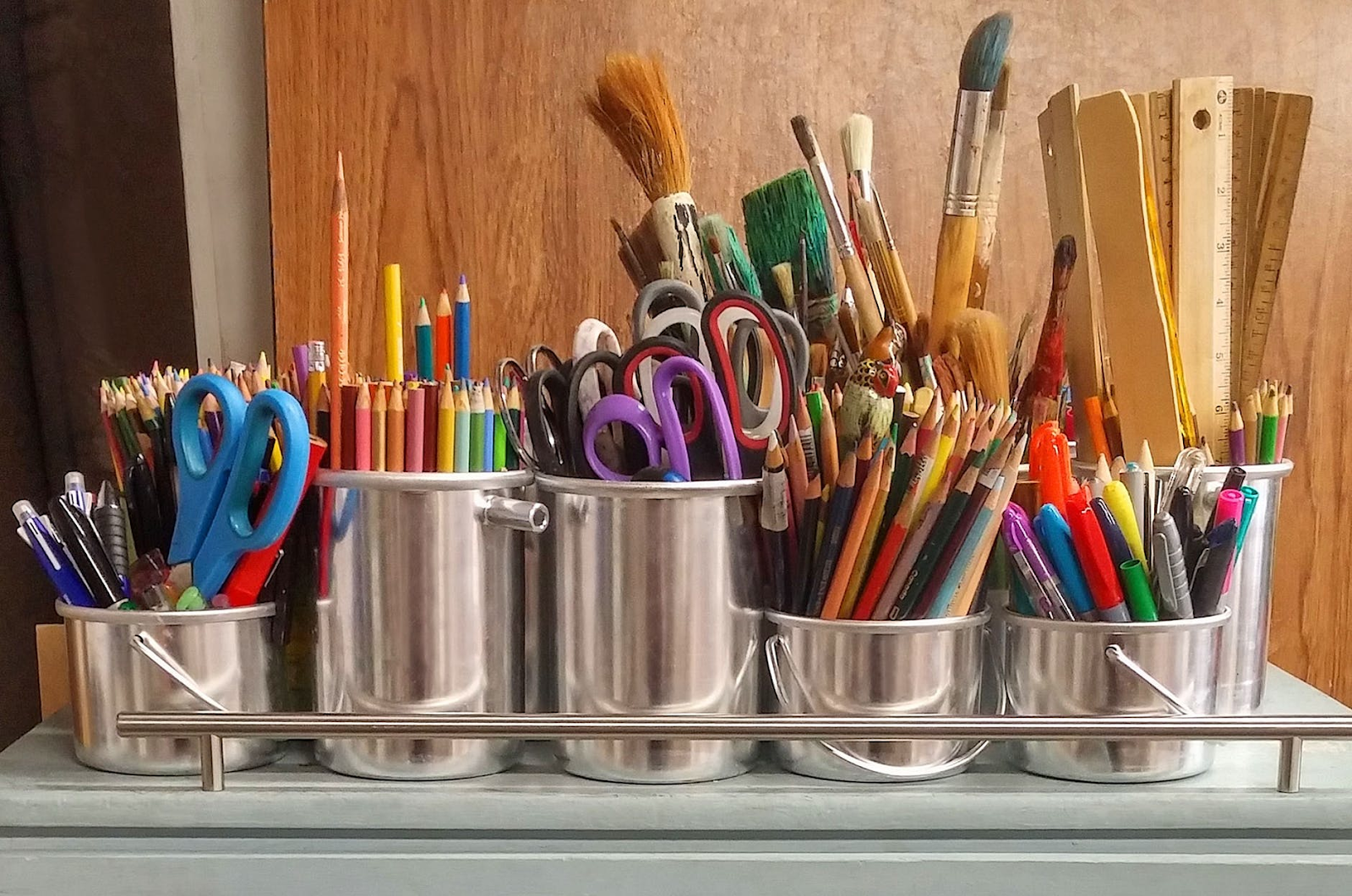 school supplies including pencils, scissors, sharpies, rulers, and paintbrushes