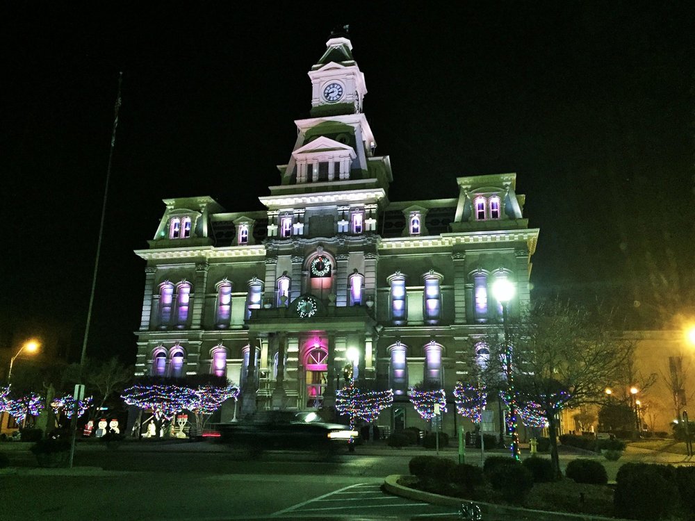 lit building and trees at night