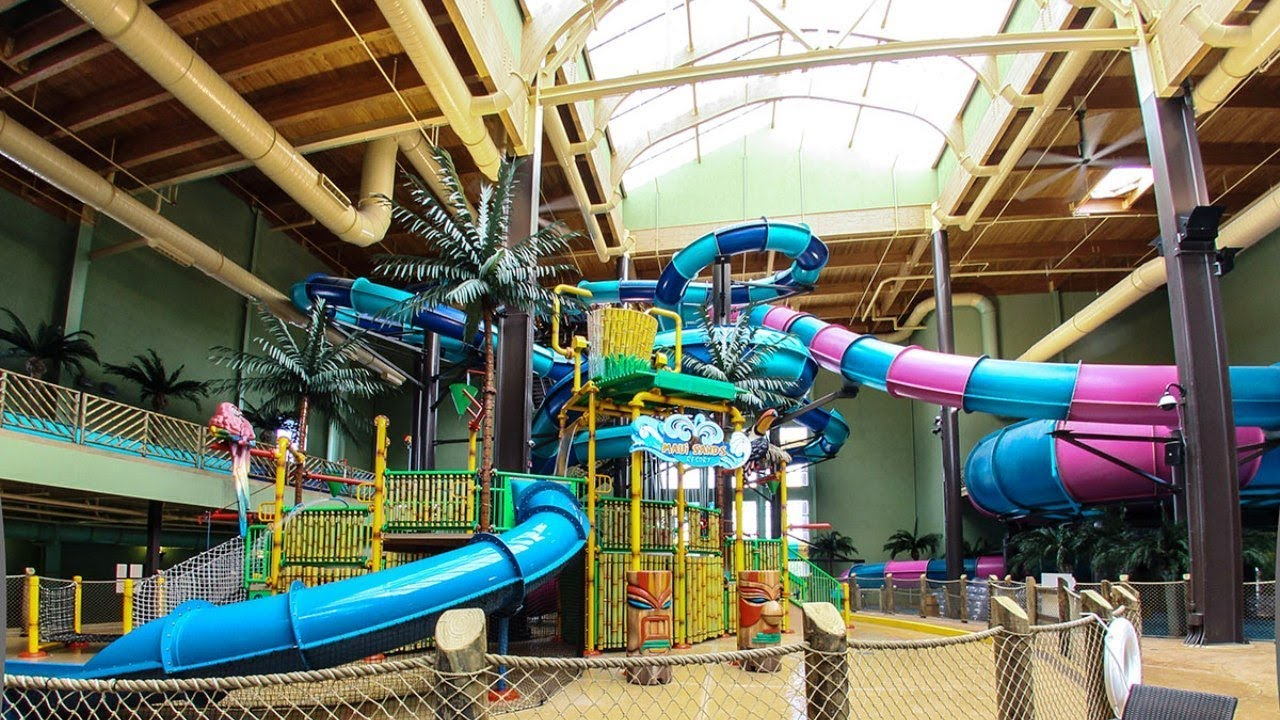 large blue and pink slides in indoor waterpark