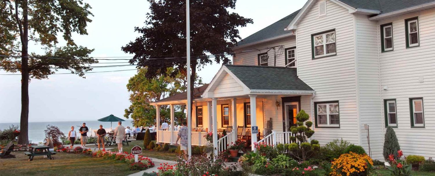 people walking on sidewalk in front of Lakehouse Inn