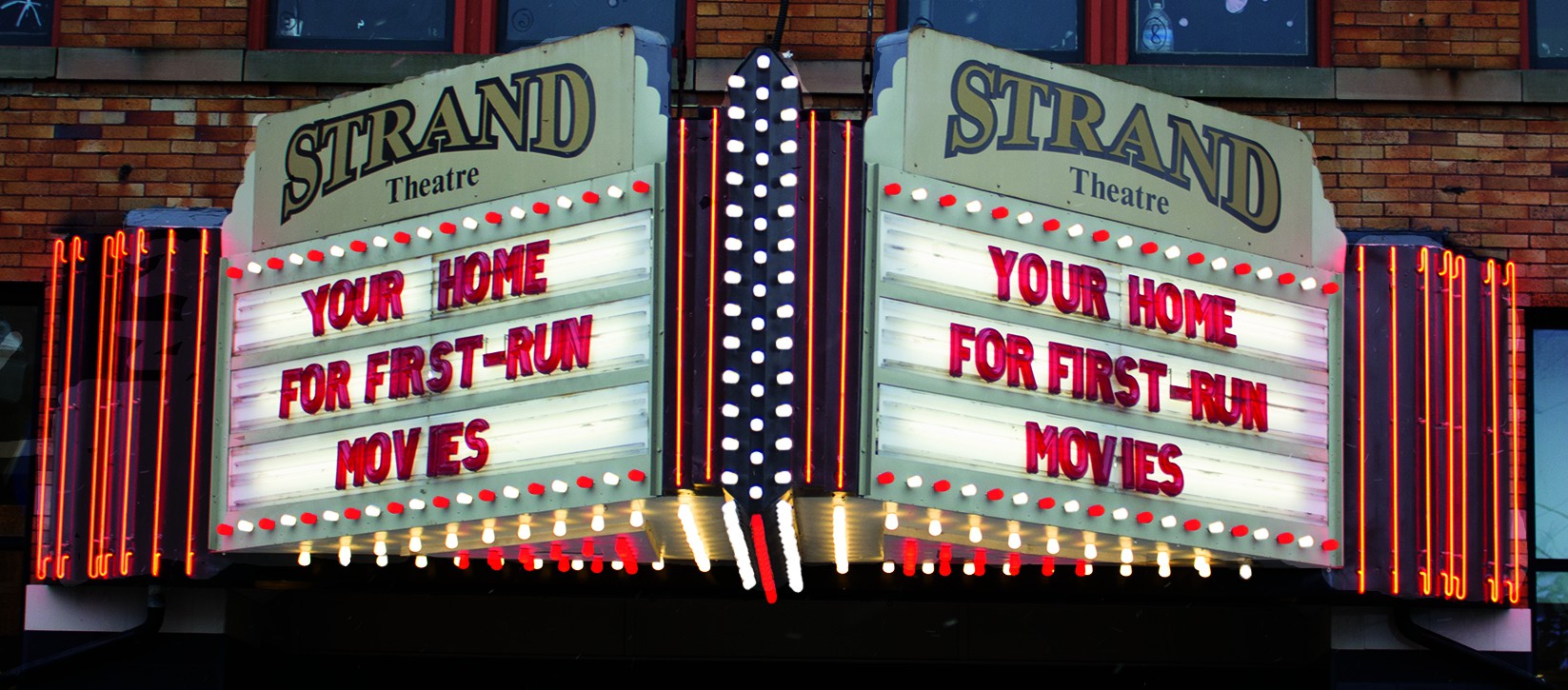 outside of Strand Theatre with old school movie theater sign