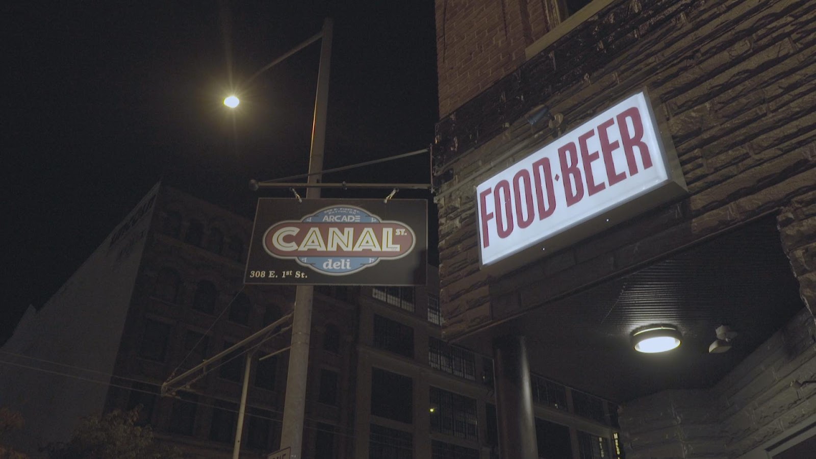 Canal Street Arcade & Deli sign next to a food & beer sign