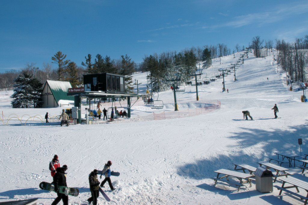 snow covered hill and snowboarders at Mad River Mountain OH