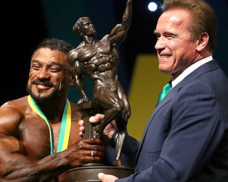 Arnold & winner holding Arnold Classic trophy