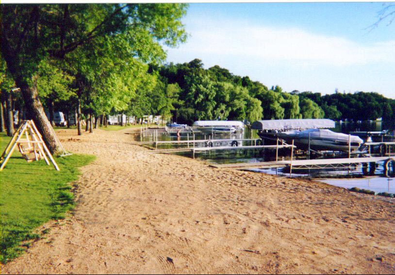 boat docks and sand trail in front of woods