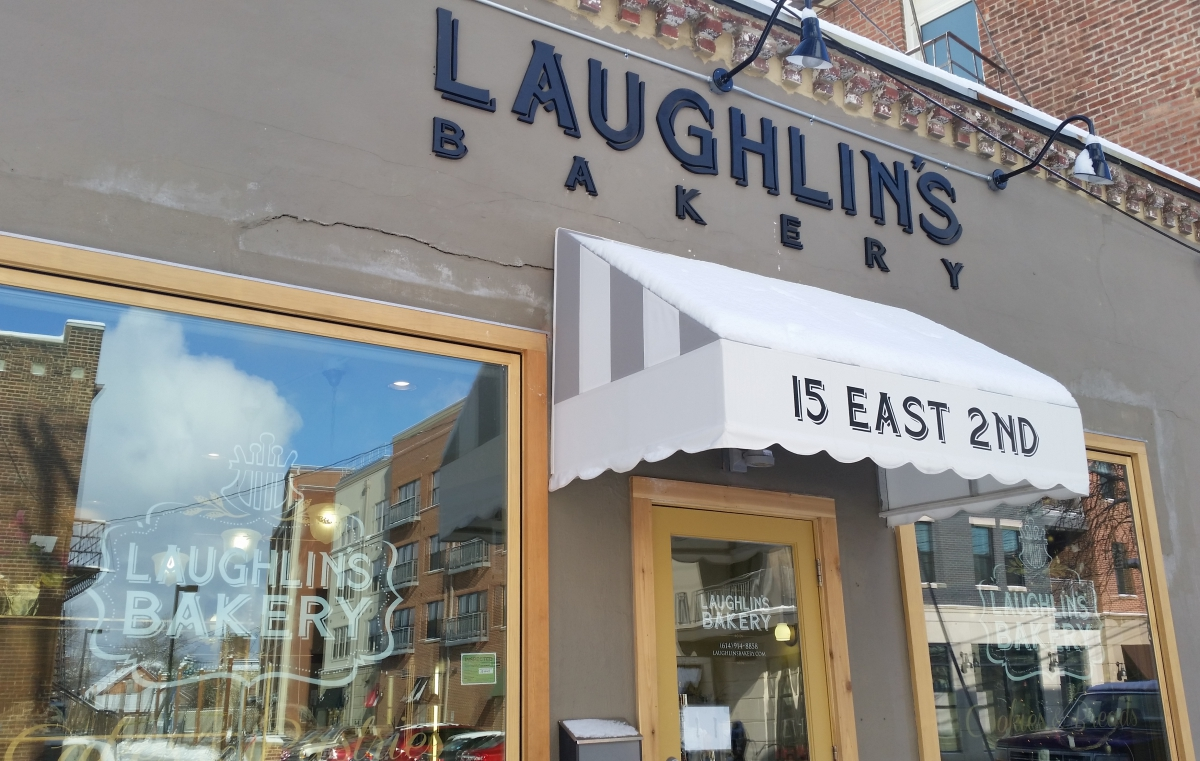 front of Laughlin's Bakery building with windows that read "Laughlin's Bakery"