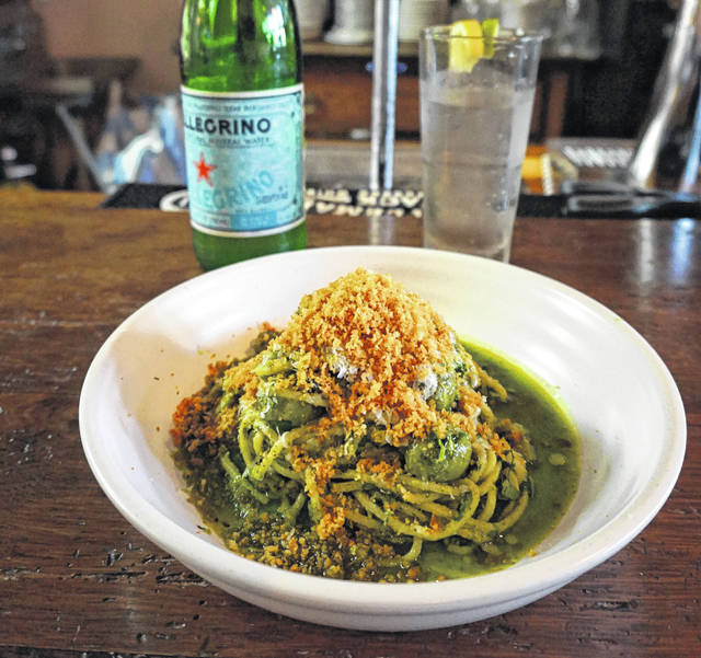 Handmade pasta in a green sauce