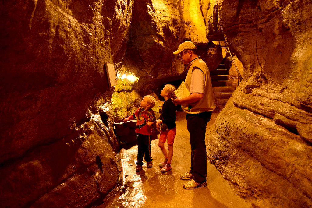 A dad and two kids touring the Olentangy Indian Caverns