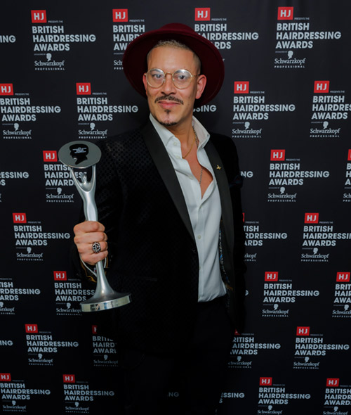 Rick Roberts with HJ British Hairdressing Awards Afro hairdresser of the Year trophy