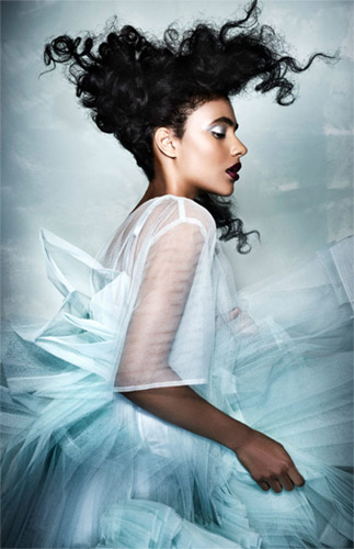 Model from Rick Robert's Afro Hairdresser of the year winning collection. Wearing curly hair and ice blue dress