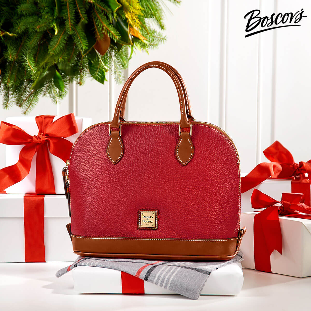 Photo of a red Dooney and Burke purse surrounded by presents