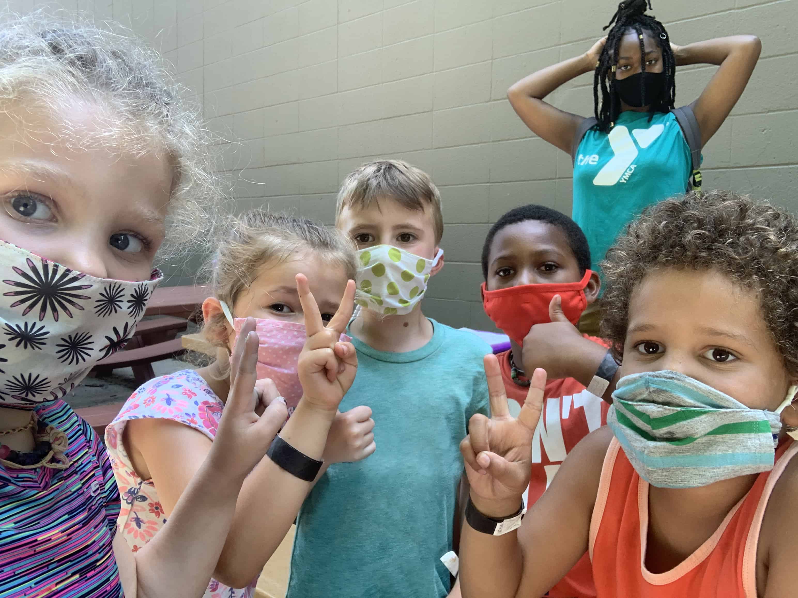 Children in a group wearing masks