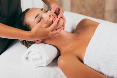 Woman on a spa receiving a facial massage