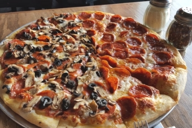 Half pepperoni pizza and half pepperoni pizza with mushrooms and black olives.