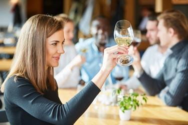 Woman looking at her glass of wine