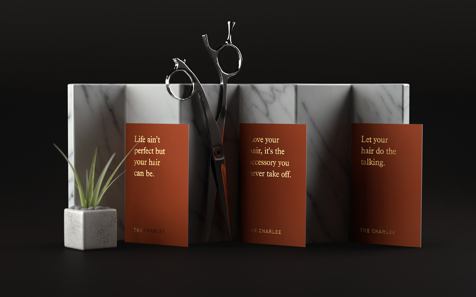 Reservation cards with gold foil accents resting on a piece of marble alongside a pair of scissors