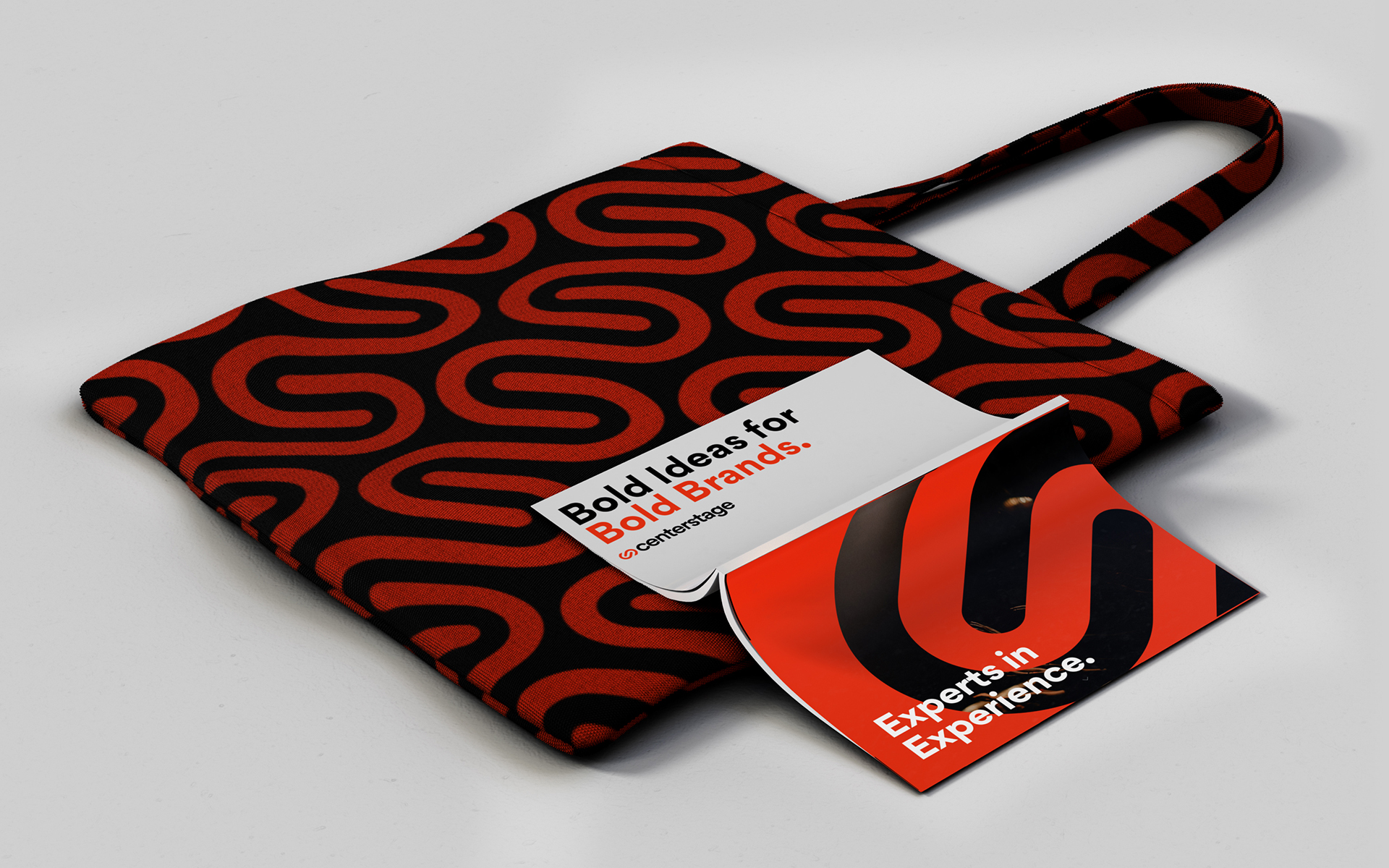tote bag featuring patterned Centerstage logo with book laying open on top