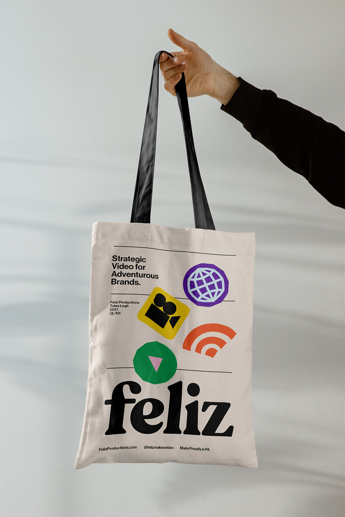 Feliz Productions branding mockup of a tote bag
