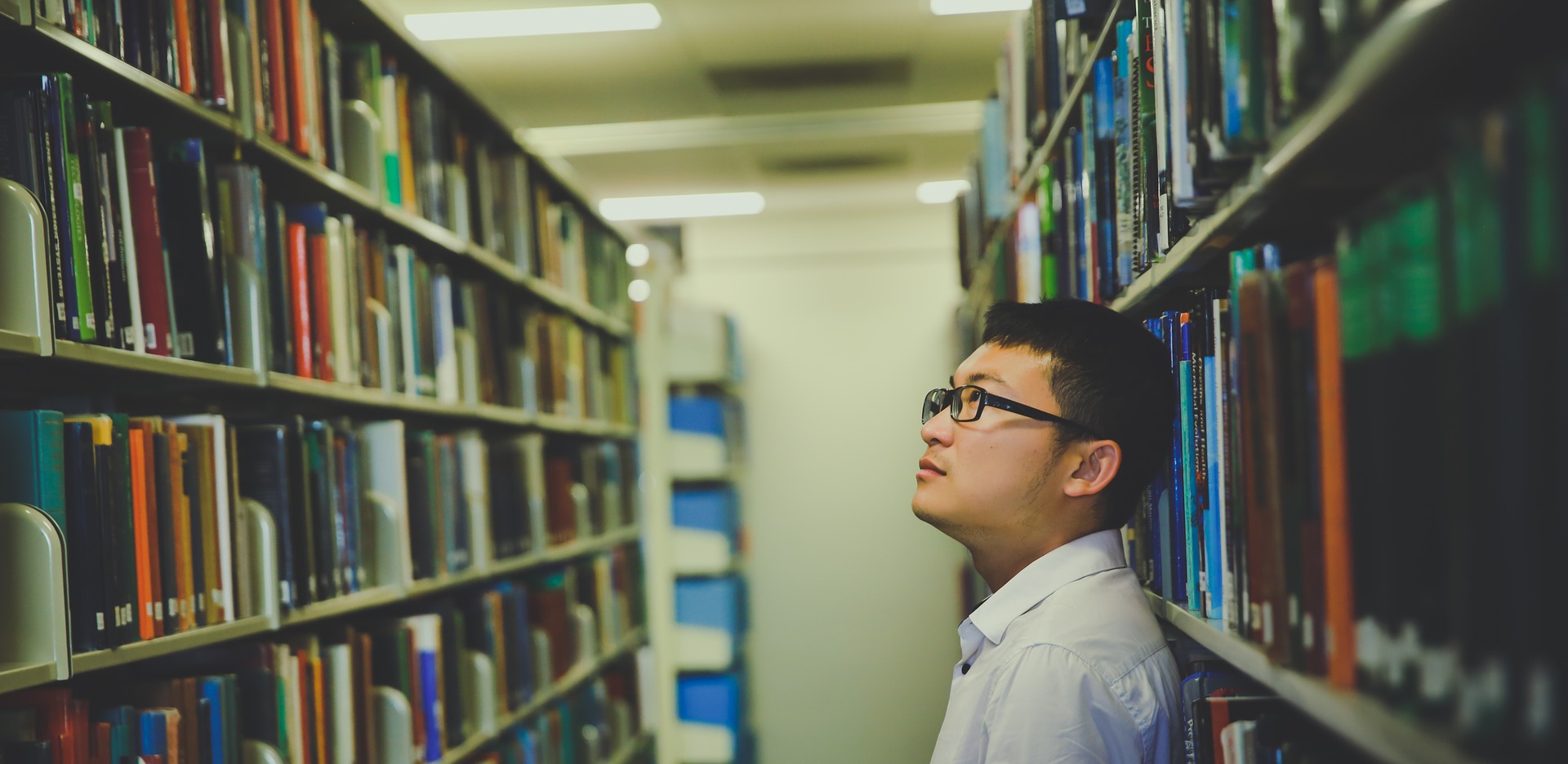 Student looks at books in the school library.