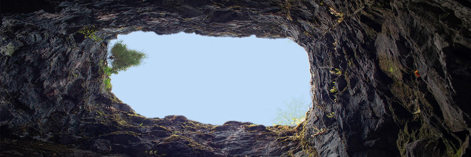 View looking up at the sky from inside of a pit
