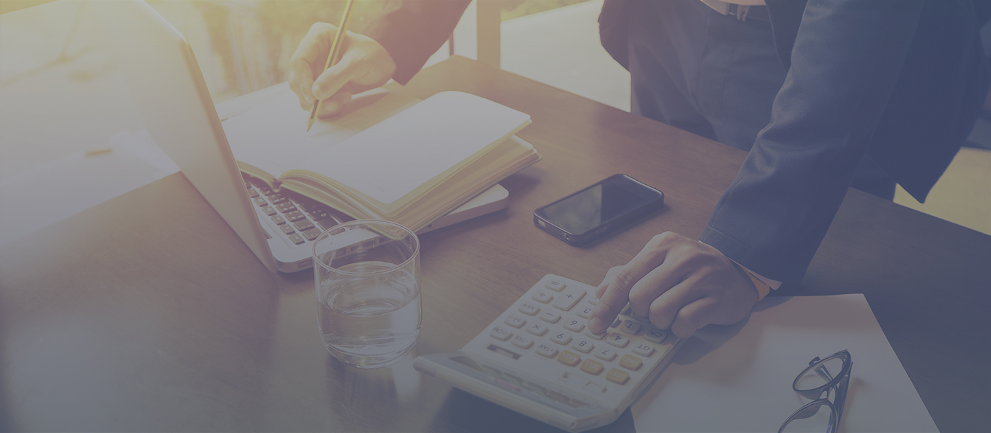 guy in suit using calculator