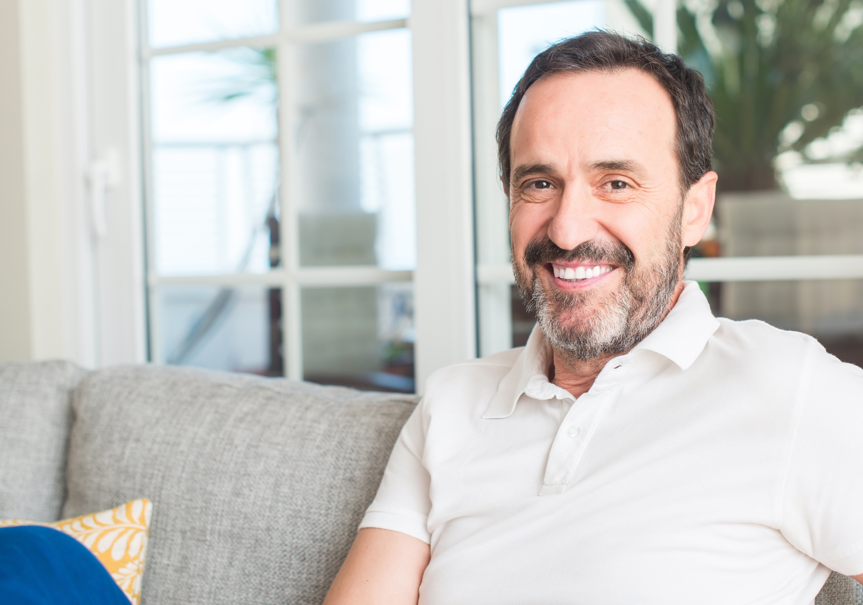 Man smiling on a couch