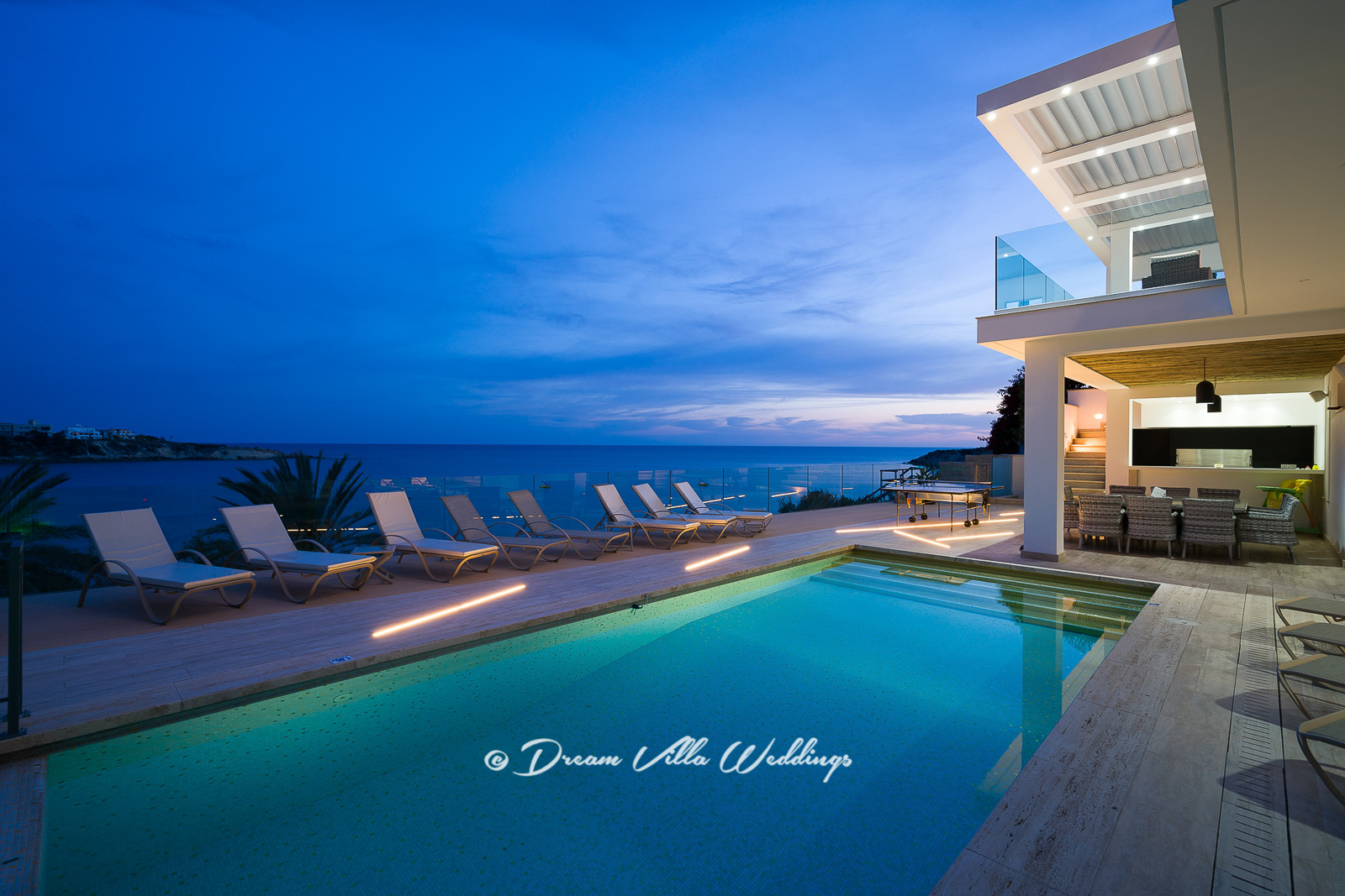 Swimming pool at sunset looking out to the sea