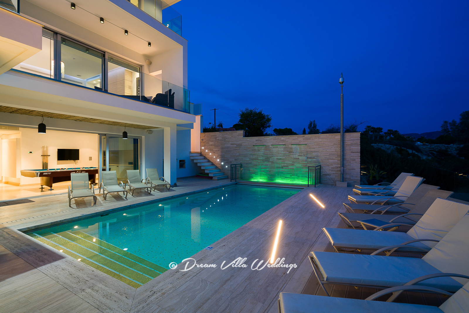 Swimming pool at sunset lit up