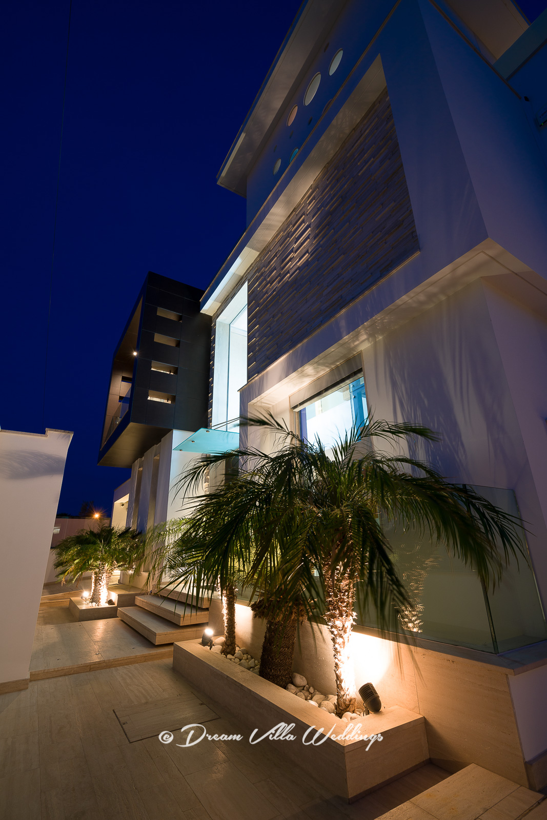 The front of the villa lit-up at night