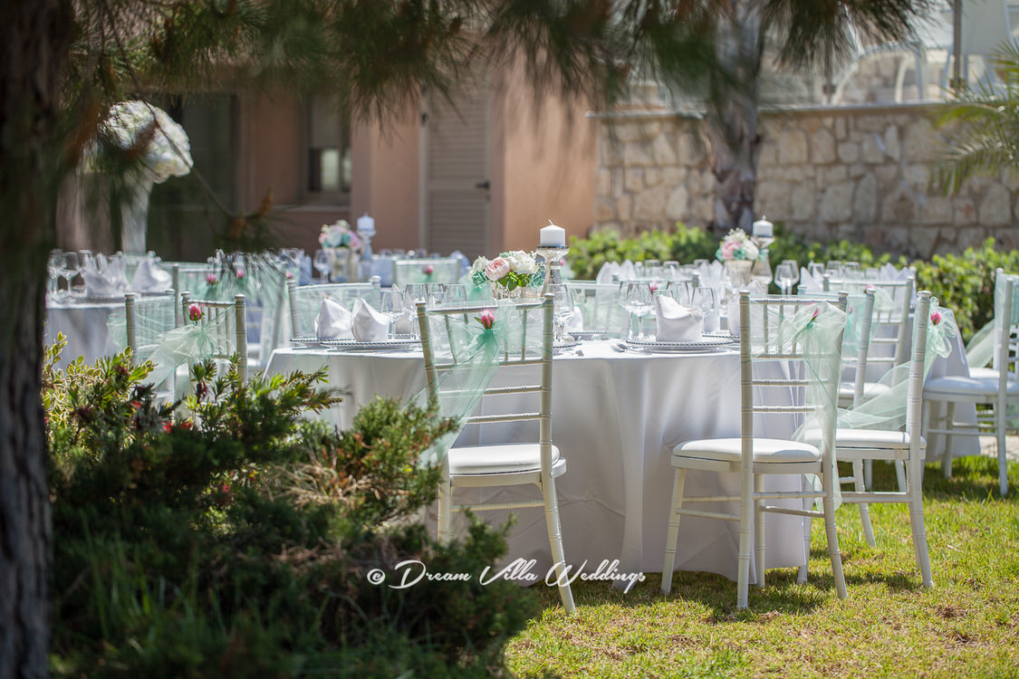 wedding tables set up on lawn by beach