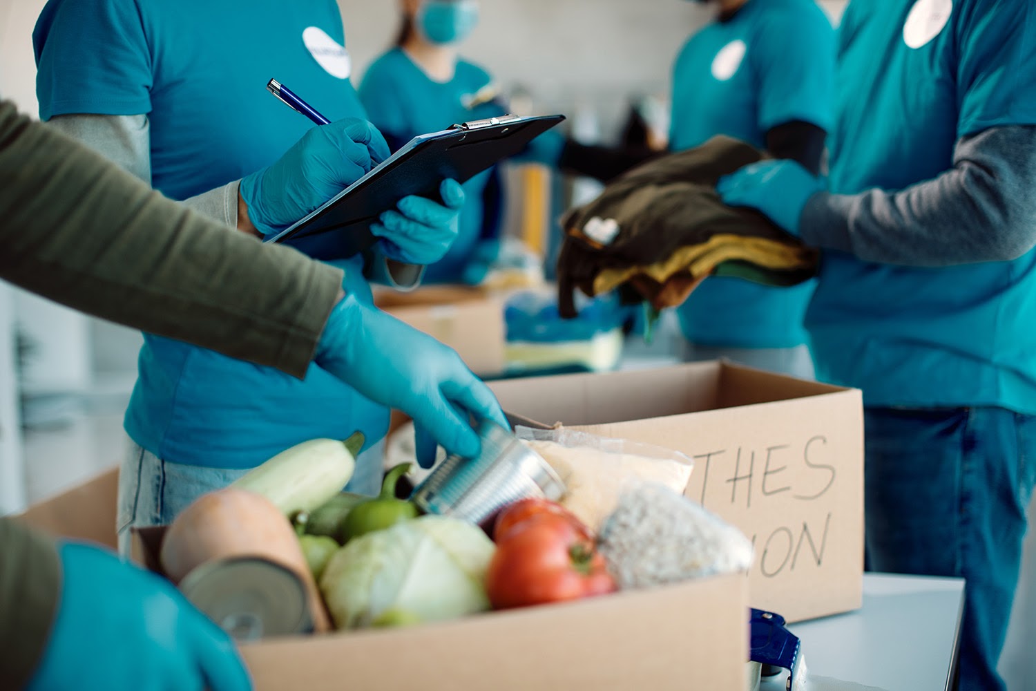 GoFundMe charity: Group of people packing donation boxes