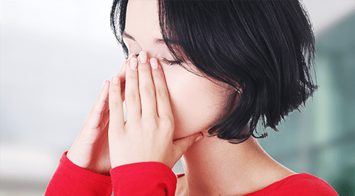 Woman suffering from sinus pressure