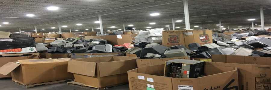 Large stockpile of old CRT monitors in boxes