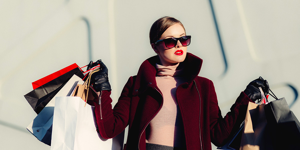 Model carrying branded shopping bags