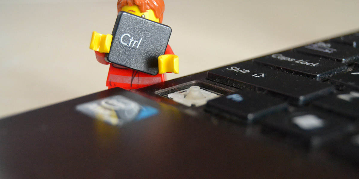 A lego figure removing the CTRL key from a computer keyboard