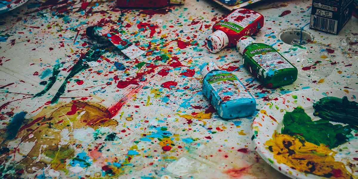 A messy table covered in paint