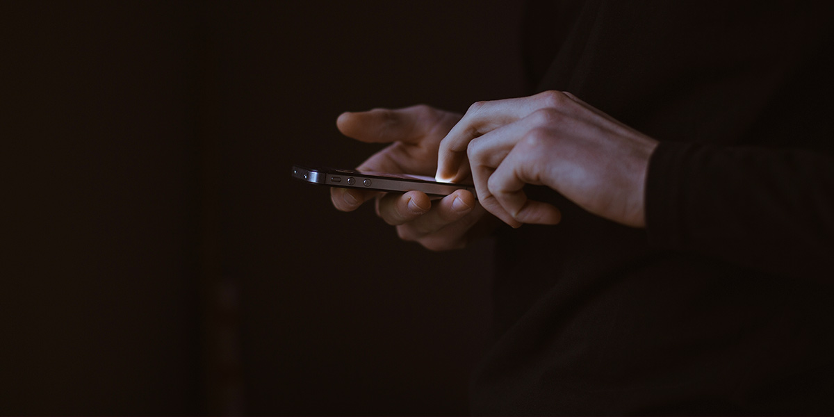 A person typing on a mobile phone