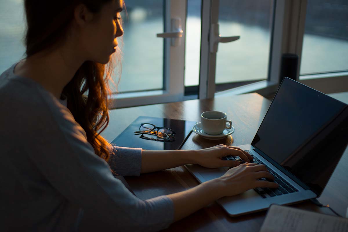 Woman typing on a laptop