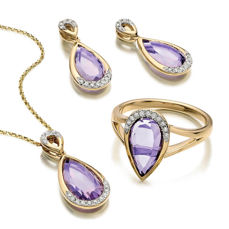 Jewellery suite of pendant, earrings and ring in yellow gold with gemstones