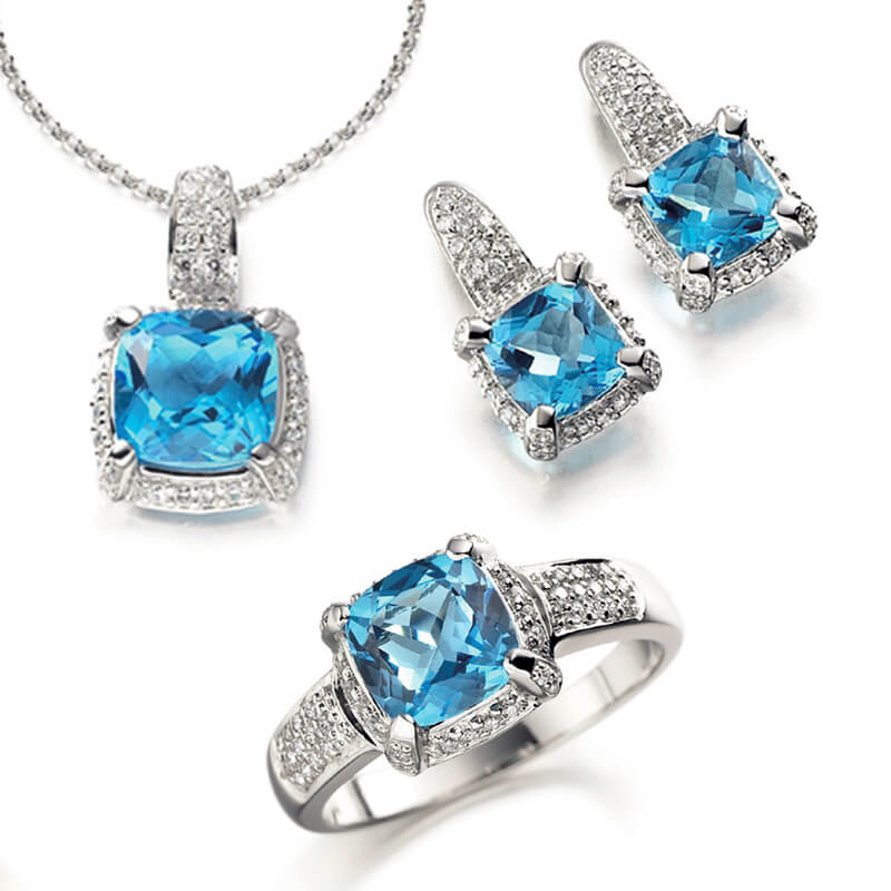 Jewellery suite of pendant, earrings and ring in white gold with gemstones
