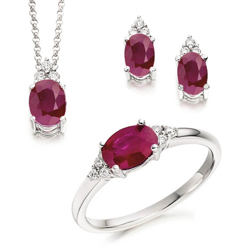 Jewellery suite of pendant, earrings and ring in white gold with gemstones
