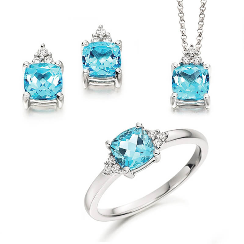 Jewellery suite of pendant, earrings and ring in white gold with gemstones