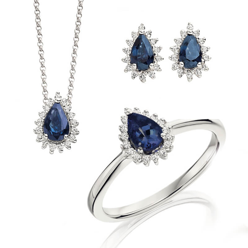 Jewellery suite of pendant, earrings and ring in white gold with gemstones